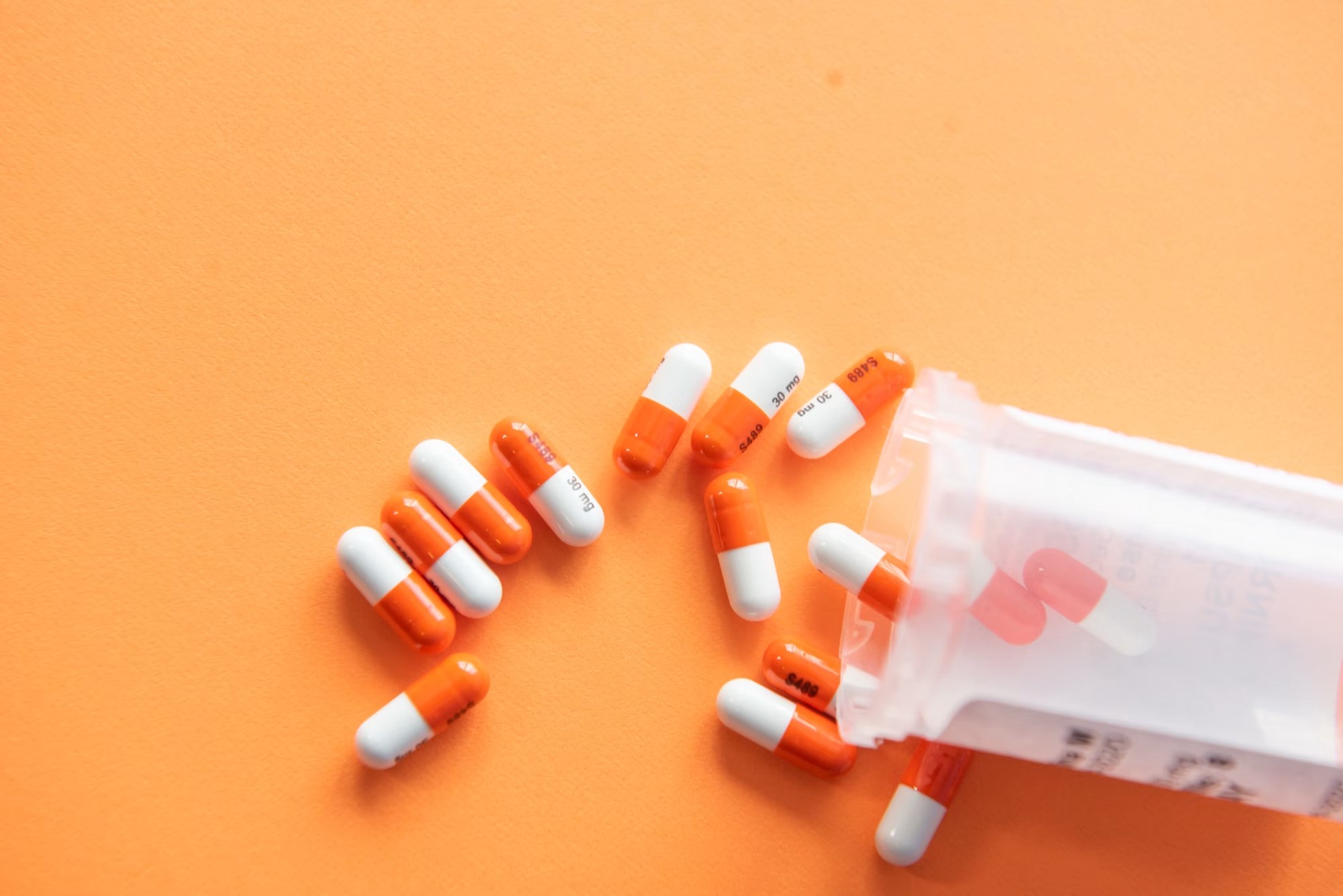 Orange and white prescription capsules